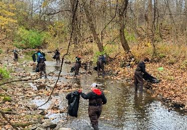 Volunteers cleaning up Pogue's Run creek
